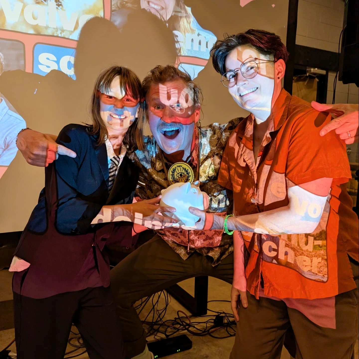 2025 Side Hustle Film Fest Poppin' Visuals winners Luke Trautwein with daughter Pearl and Gina Valvo — holding the 3D printed coin pig award